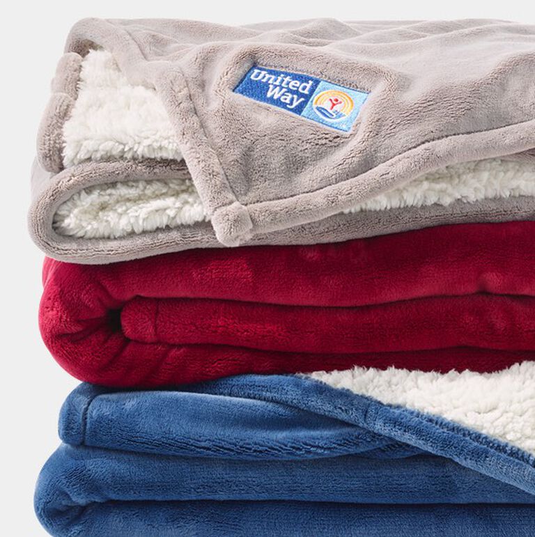 Stack of Wicked Plush Sherpa Throws with Logo
